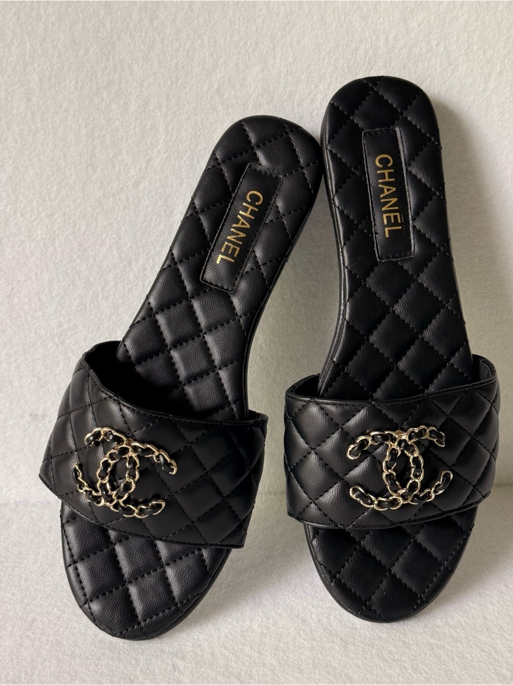 CHANEL Black Quilted Leather Slide Mules with Gold CC Chain